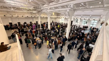 Visitatori tra gli stand di Watches of Italy, ripresi dall'alto in una sala con grandi finestre, in un'edizione precedente